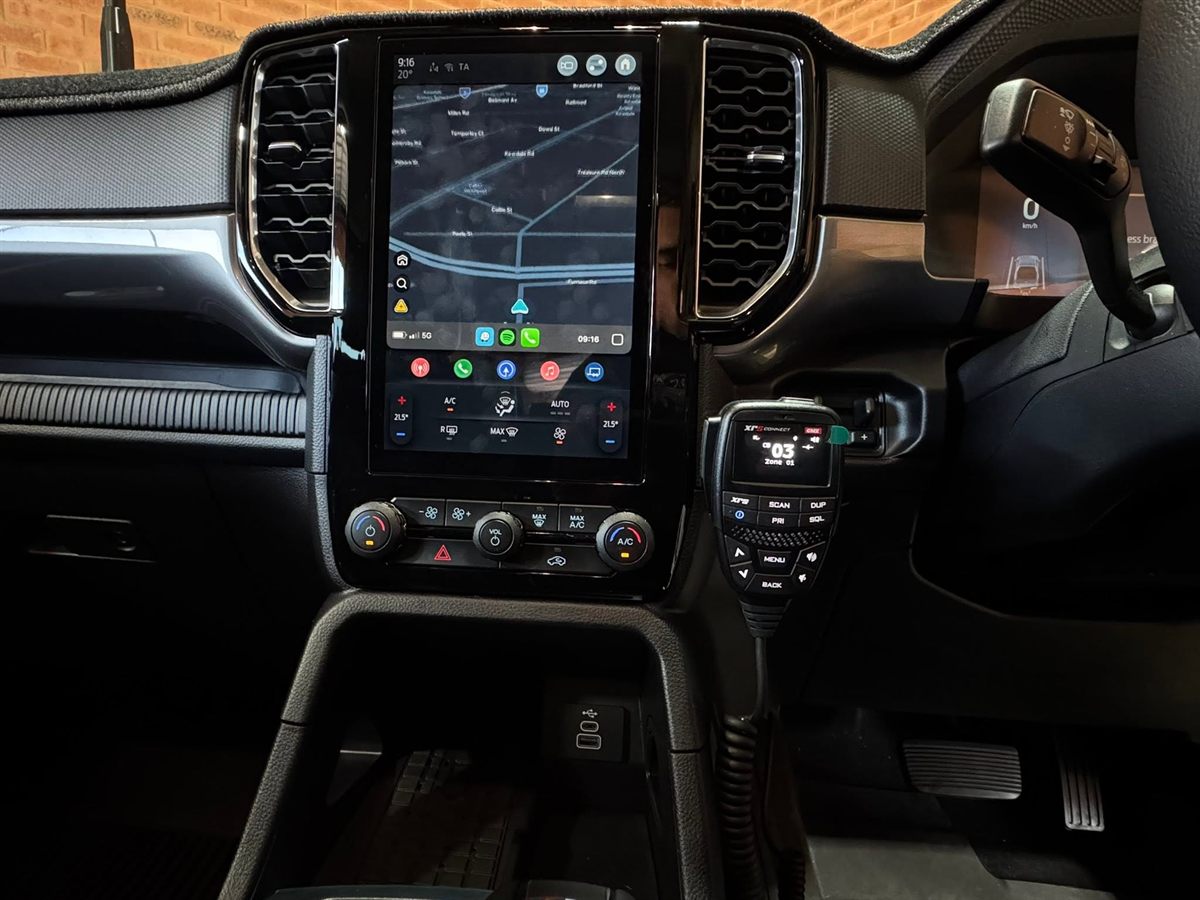 GME XRS Connect UHF handset mounted beside a large touchscreen