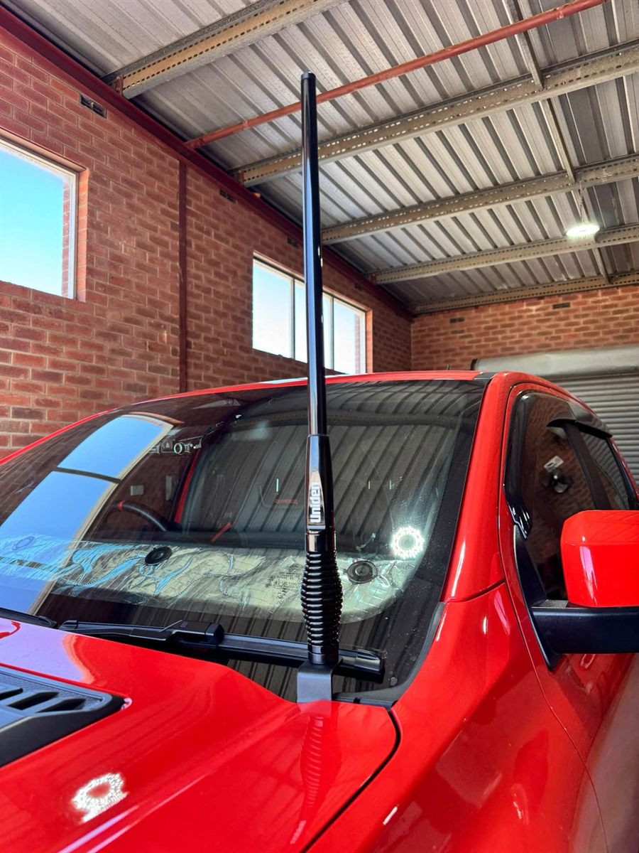 Uniden UHF antenna fitted to a red ute