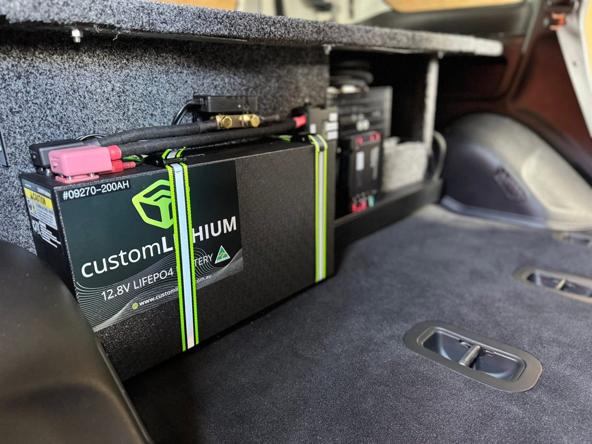 Custom Lithium 200Ah lithium battery strapped down beside a drawer system