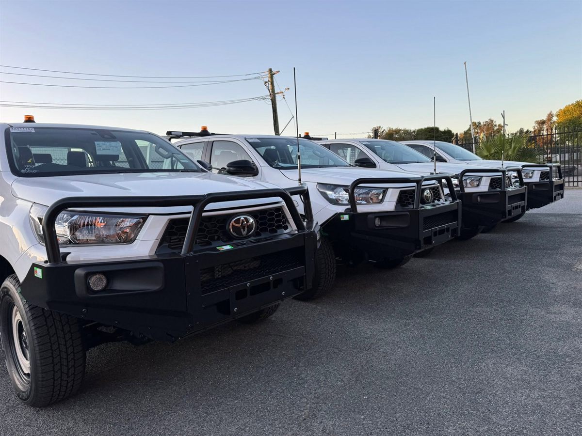 Line of fleet Hilux utes with bullbars and amber beacons