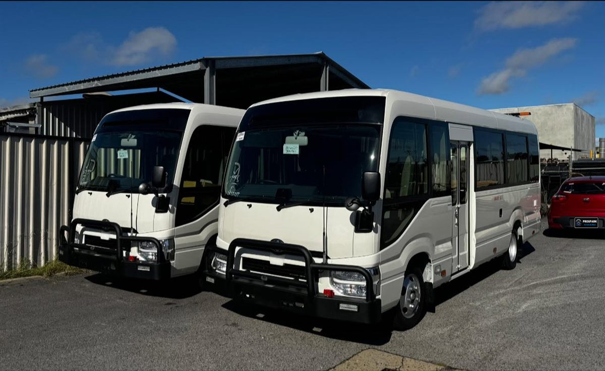 Two Toyota Coaster buses fitted with bullbars