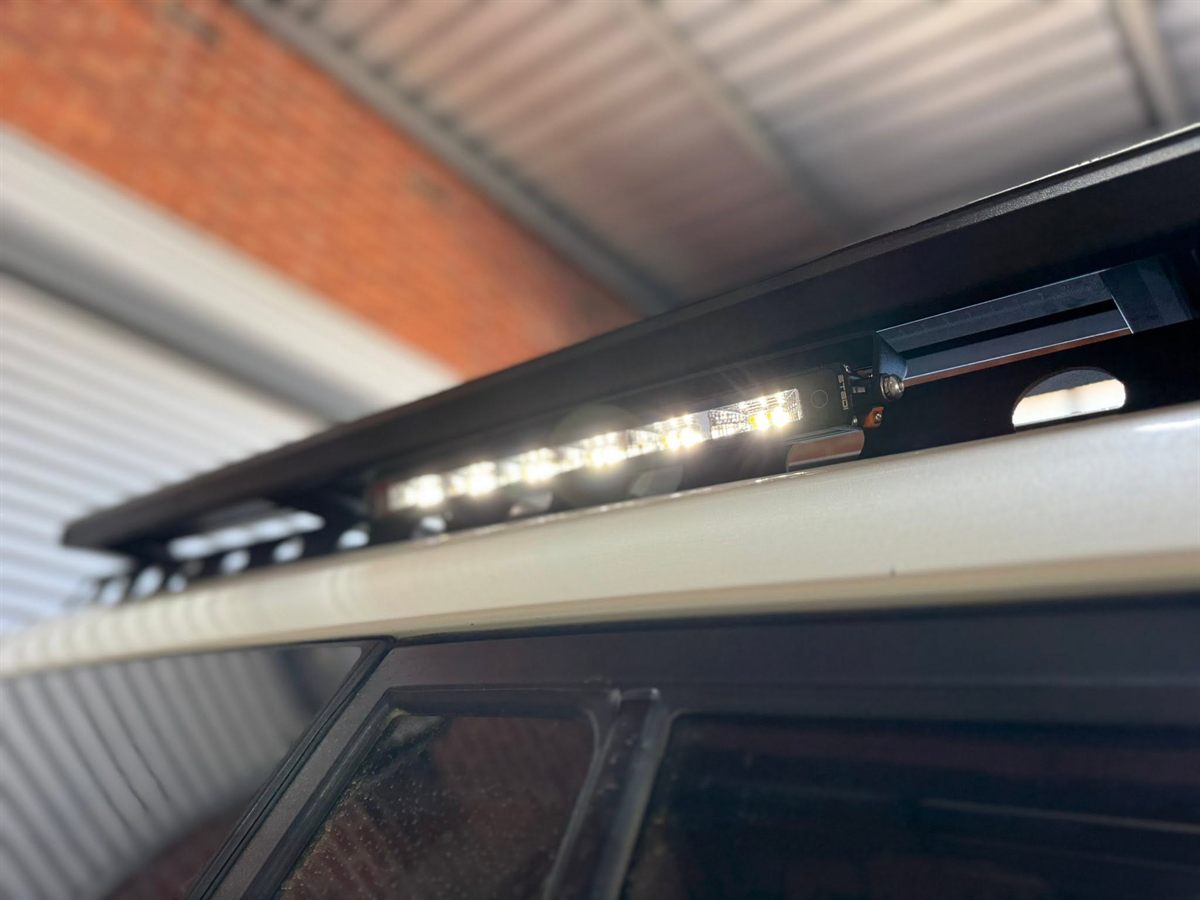 Slimline LED light bar under the edge of a roof rack