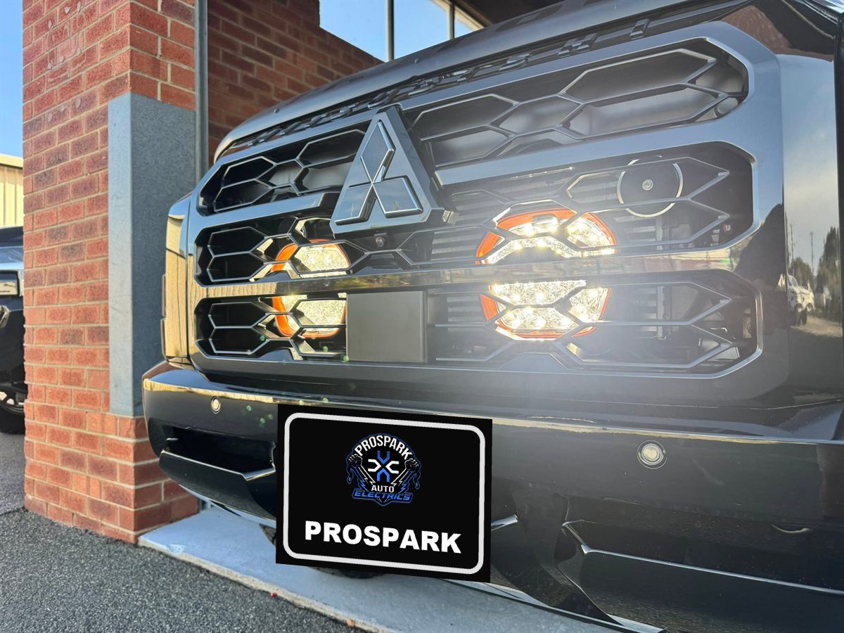 Mitsubishi Triton with round LED driving lights fitted in the grille, switched on