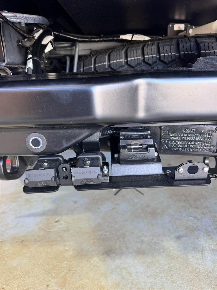 Trailer plug wiring under the rear of a vehicle